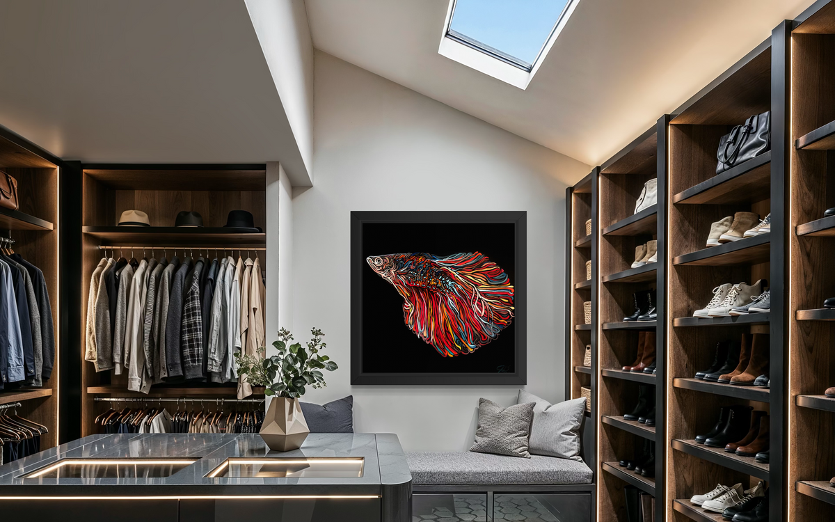 A framed wall art print Jeff Dillon FIne Art featuring a colorful stylized fish on a black background, displayed in a modern, well-lit walk-in closet with shelves, clothing, shoes, and a bench.