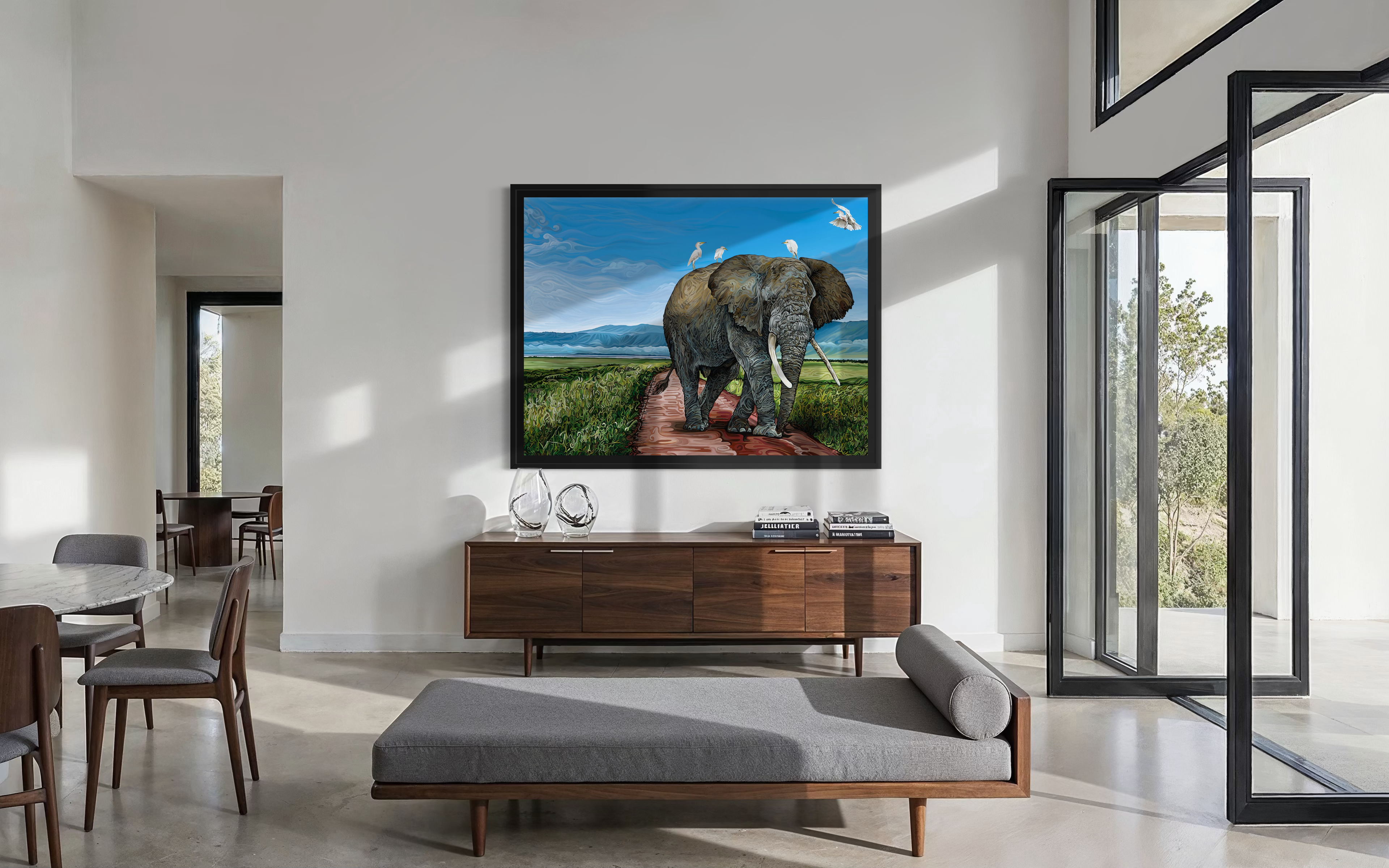 A wildlife painting titled Ngorongoro: Where Giants Walk depicts an elephant on a grassy path with birds riding its back.