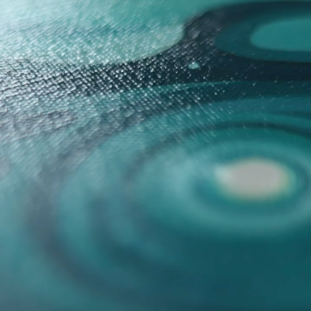 Close-up of a textured blue surface with circular patterns of jeff dillon paintings 